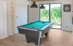 a billiard table in a living room with at Cozy Home In Glesborg With Sauna in Glesborg