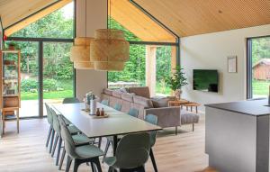 a dining room and living room with a table and chairs at Cozy Home In Glesborg With Sauna in Glesborg
