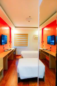 a hospital room with two beds and two monitors at YMCA Makati in Manila