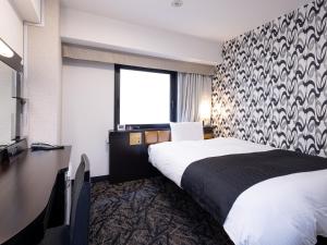 a hotel room with a bed and a large window at APA Hotel Nagoya Sakae Ekimae EXCELLENT in Nagoya