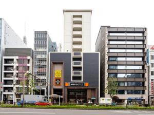 a building in a city with tall buildings at APA Hotel Nagoya Sakae Ekimae EXCELLENT in Nagoya