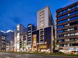a tall building in a city with a street at APA Hotel Nagoya Sakae Ekimae EXCELLENT in Nagoya