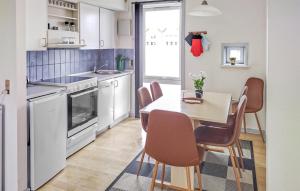 a kitchen with a table and chairs in a room at Lejlighed 190 in Rømø