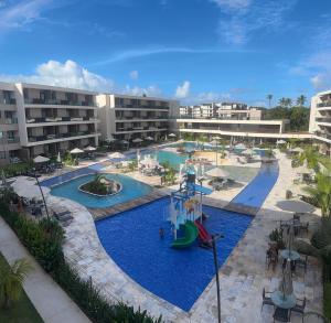 an image of a resort pool with slides at Malia Beach Muro Alto 300 Metros Do Mar in Porto De Galinhas