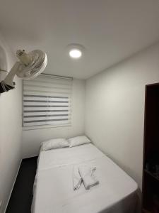 a small room with a bed with a towel on it at Apartamento vacacional Vallesue en Flandes, Tolima in Flandes +17 photos