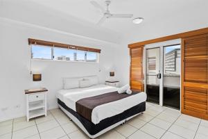 a bedroom with a bed and a window at Cairns City Apartments in Cairns