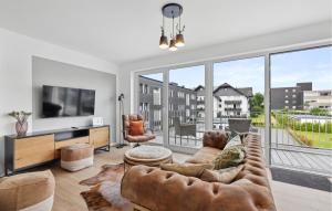 a living room with a couch and a large window at Gebirgsresort Winterberg in Winterberg