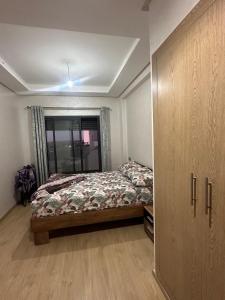 a bedroom with a bed and a large closet at Ocean Park Apartment for rent in Casablanca