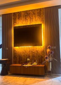 a living room with a large television on a wall at Ocean Park Apartment for rent in Casablanca