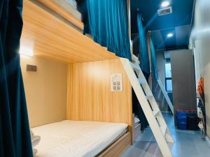a bedroom with a bunk bed in a room at Dielang Youth Hostel in Guangzhou