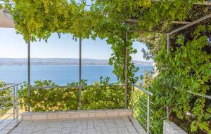a room with a view of the water at 2 Bedroom Stunning Apartment In Stanici in Stanići +10 photos