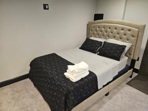a hotel room with a bed with a white towel on it at Solo travelers and couple in Sterling +14 photos