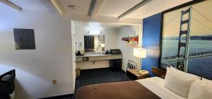 a hotel room with a bed and a sink at Hotel Belmont in Belmont