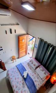 a bedroom with a bed in a room with a door at Casa Carauarí in Alter do Chao +22 photos