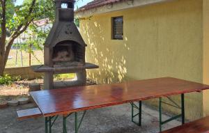 a wood fired oven sitting next to a bench at Four-Bedroom Holiday Home Krusevo With Sea View 05 in Anić +22 photos