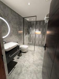 a bathroom with a sink and a toilet and a shower at Ayana Resorts in Hyderabad +22 photos