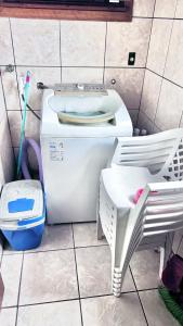 a white toilet in a bathroom with a toothbrush at Ampla e luxuosa casa com áreas de lazer in Pelotas +26 photos