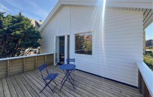 two chairs and a table on the porch of a house at 3 Bedroom Amazing Home In Farsund in Farsund