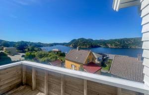 a balcony with a view of a river at 3 Bedroom Amazing Home In Farsund in Farsund +10 photos