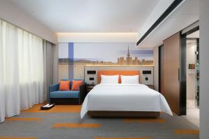 Postel nebo postele na pokoji v ubytování Hampton by Hilton Foshan Dali