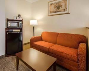 a living room with a couch and a microwave at Quality Suites Jeffersonville - Louisville North in Clarksville +28 photos