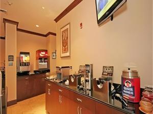 a coffee shop with a counter and a bar at Staybridge Suites Newport News in Newport News +6 photos