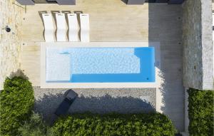 an overhead view of a swimming pool with two chairs at Villa K4 in Zadar +42 photos