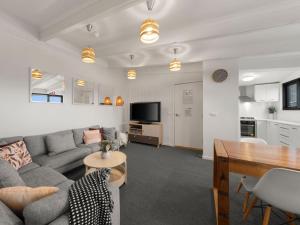 a living room with a couch and a table at SKI View 4 in Mount Buller