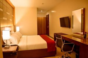 a hotel room with a bed and a desk at Hotel Veniz - Session in Baguio +58 photos