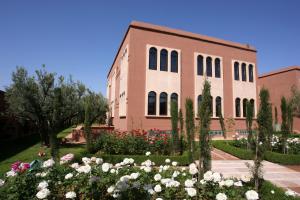 a building with a bunch of flowers in front of it at Al Fassia Aguedal in Marrakech