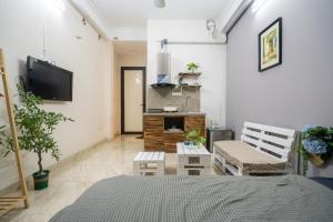 a room with a bed and two chairs and a tv at Homestay Nhacuabu in Hanoi
