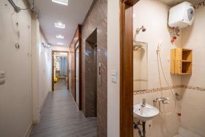 a corridor of a bathroom with a sink and a shower at Homestay Nhacuabu in Hanoi +74 photos