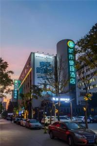 a large building with cars parked in front of it at City Comfort Inn Shantou Huashan Road the MixC in Shantou