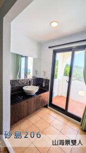 a bathroom with a sink and a large window at ShaDao 206 in Kenting +41 photos