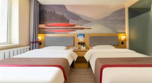 a room with three beds and a painting on the wall at Thank Inn Plus Hotel Xinjiang Urumqi Tianshan District Bingtuan Erzhong in Ürümqi +135 photos