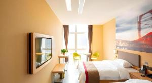 a hotel room with two beds and a television at Thank Inn Hotel Tianjing Jinnan University in Tianjin