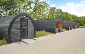 a row of black domed houses with a door at Nice Apartment In Nørre Nebel With Wifi in Nørre Nebel