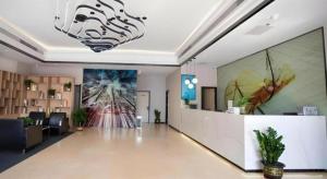 a lobby with a large painting on the wall at GreenTree Inn Tangshan Nanhu International Exhibition Center in Tangshan