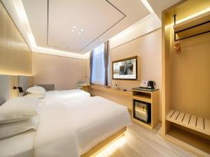 a hotel room with two beds and a fireplace at Deep Sleep Hotel Xuzhou High-Speed Railway Station East Square Oubeisha in Xuzhou