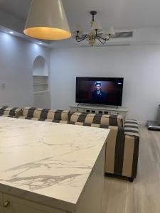 a living room with a flat screen tv and a couch at Shanghai Downtown Family Suit Near The West Nanjing Road in Shanghai