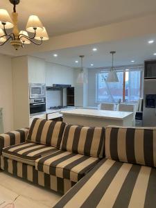 a living room with a couch and a kitchen at Shanghai Downtown Family Suit Near The West Nanjing Road in Shanghai
