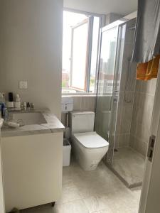 a bathroom with a toilet and a shower and a sink at Shanghai Downtown Family Suit Near The West Nanjing Road in Shanghai