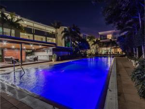 a large swimming pool with blue water at night at Ocean View Penthouse 1328 at Bells Boulevard in Kingscliff