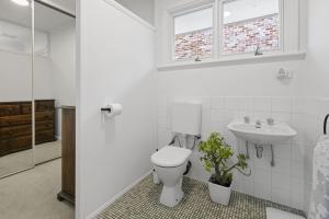 a bathroom with a toilet and a sink at Blairgowrie Beach Bungalow - Pet & Value Stay in Blairgowrie +19 photos
