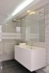 a bathroom with a white sink and a mirror at Aldeia do Priolo in Nordeste +42 photos