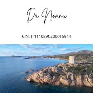 a picture of the ocean with a lighthouse on a cliff at Da Nonnu in Teulada