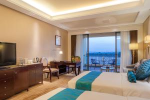 义乌Your World International Conference Centre Hotel的有两张床和一台电视的酒店房间