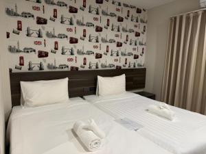 a bedroom with a bed with two white pillows at SEOUL3 HOTEL & SLOW BAR CAFE in Bangkok