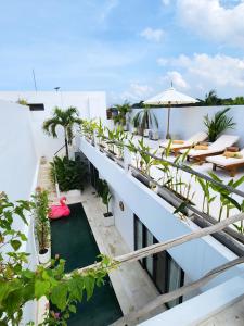 タナロットにある'Villa Vivid' 2BR Bohemian, 5 min to Kedungu Beachの建物の上にテーブルと椅子が置かれたバルコニー