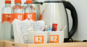 a wooden holder with bottles of water and a coffee pot at B2 Nakhon Sawan Boutique & Budget Hotel in Nakhon Sawan